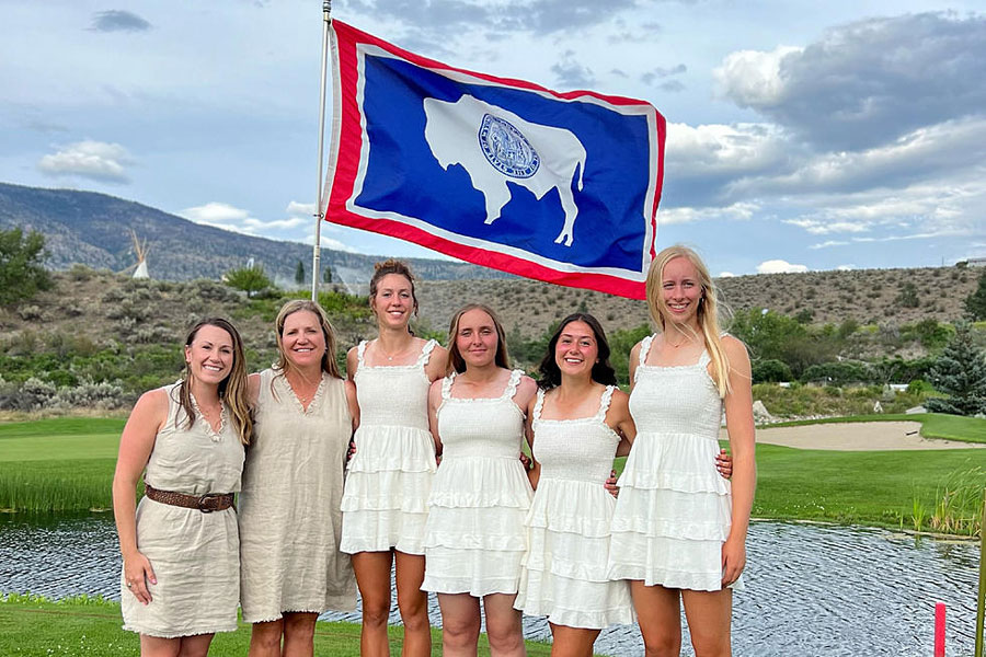 team of wyoming youth golfers in white dresses